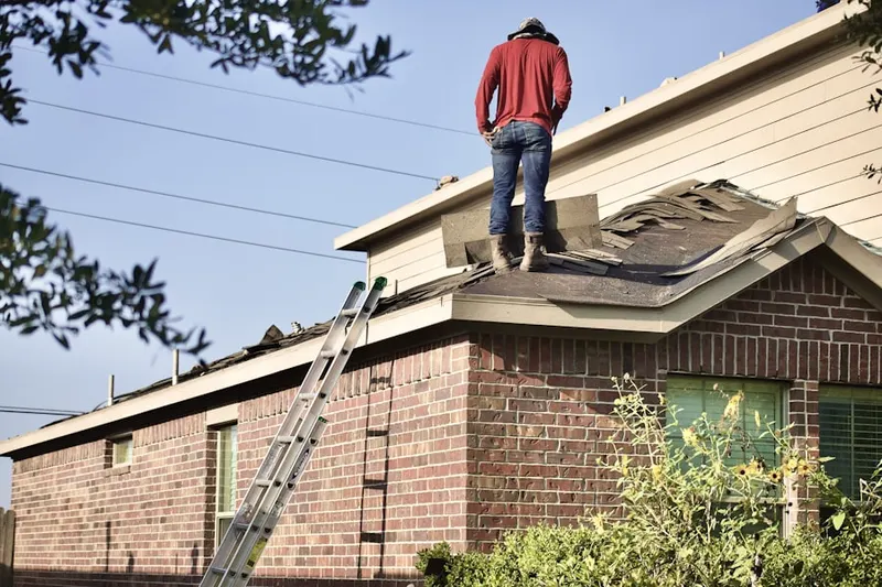 Professional roofer working on a residential roof in Batemantown